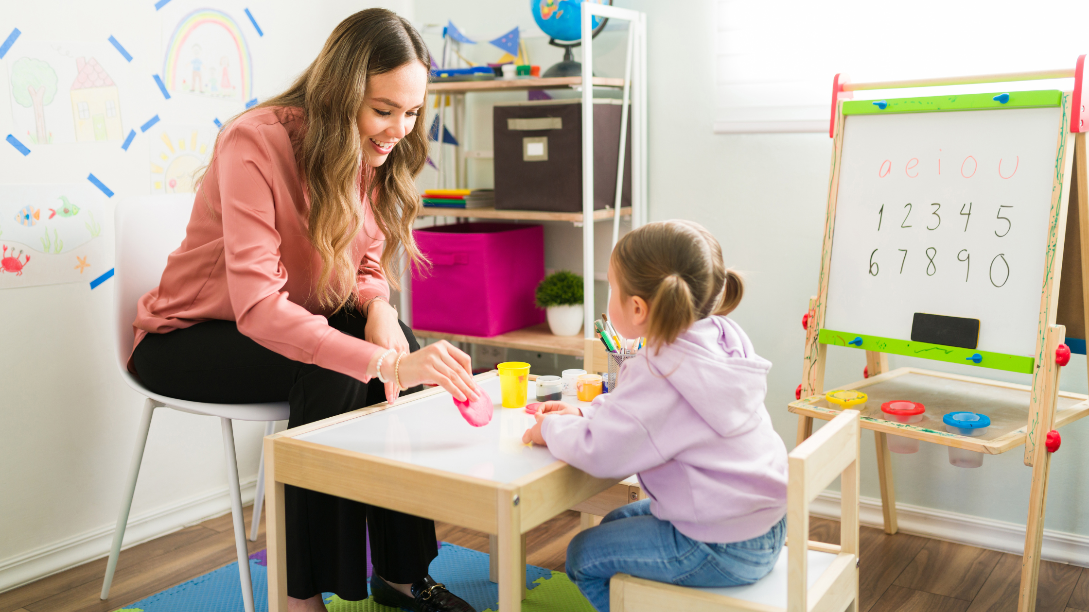 A Board Certified Behavior Analyst (BCBA) working with a child on play and social skills through ABA therapy.