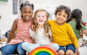 Three happy kids smiling.