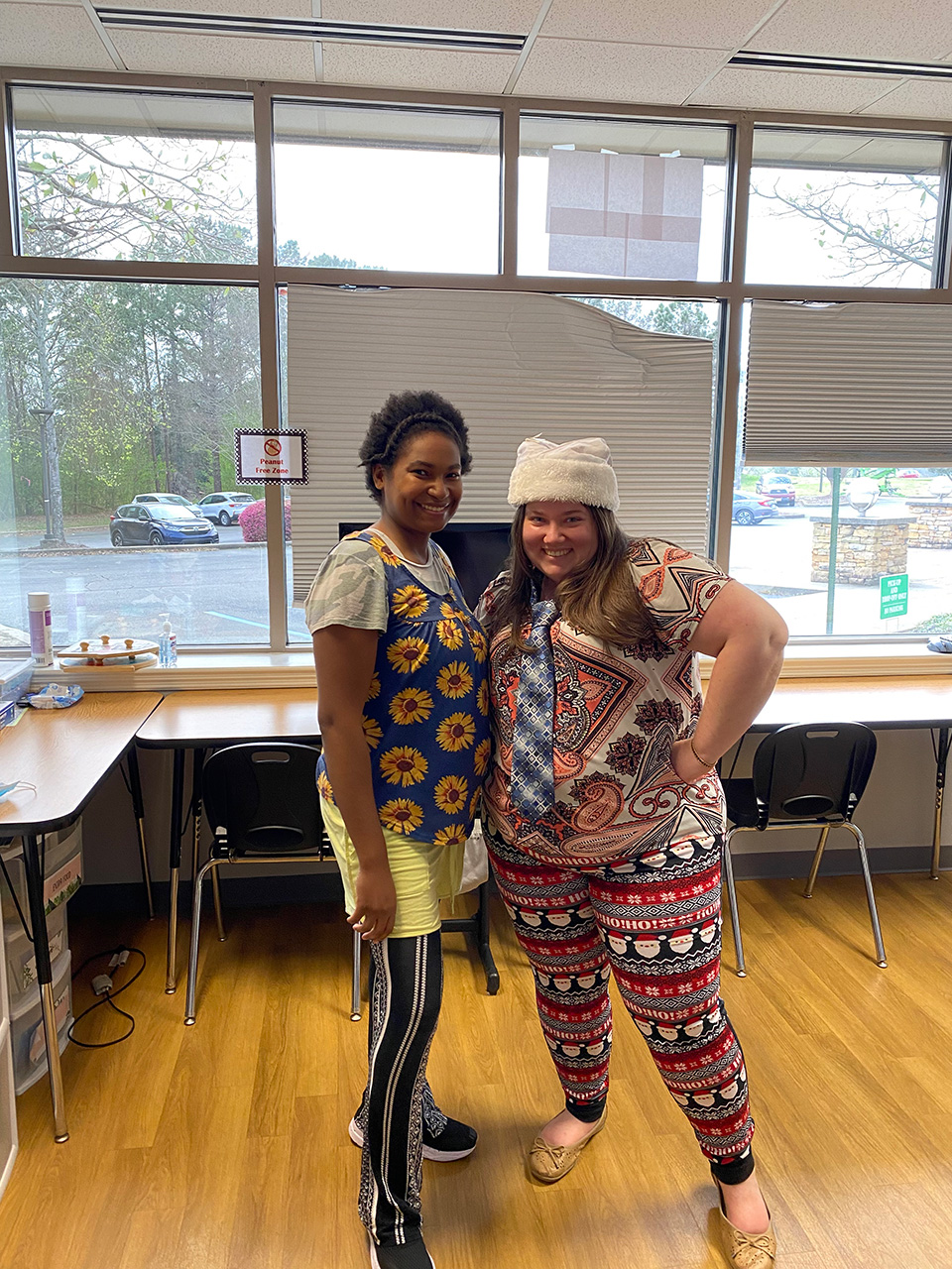 Smiling coworkers wearing funny clothes in the office.