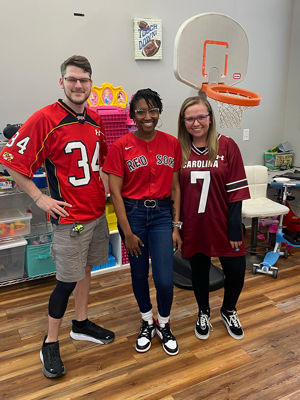 Coworkers wearing athletic team jerseys.
