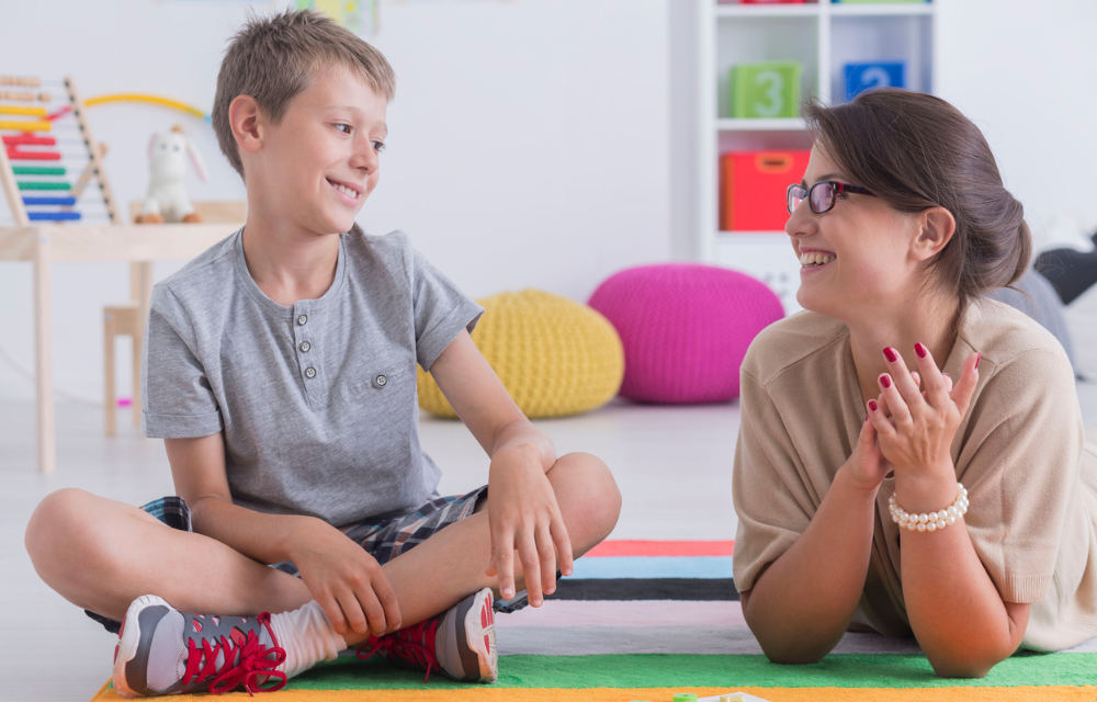 Child and mom sitting on the floor together.