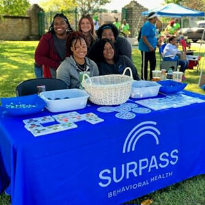 Coworkers at outdoor booth for Suprass Behavioral Health.