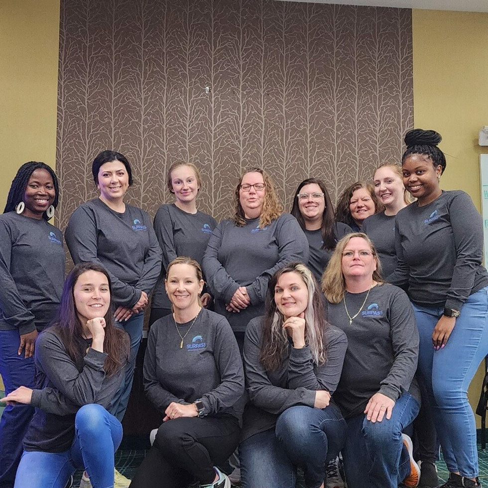 Group of employees wearing matching company shirts.
