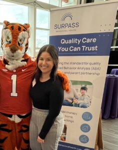 Woman standing next to sports team mascot.