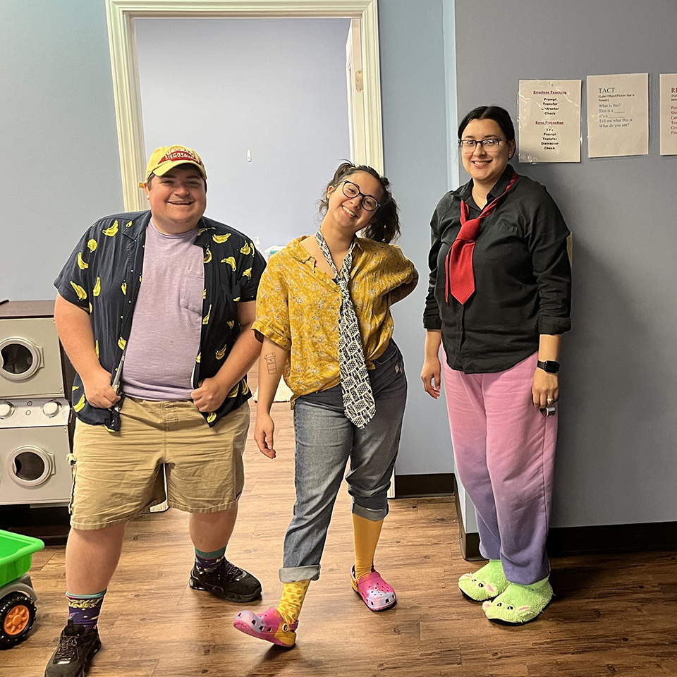 Happy co-workers wearing funny clothes in the office.