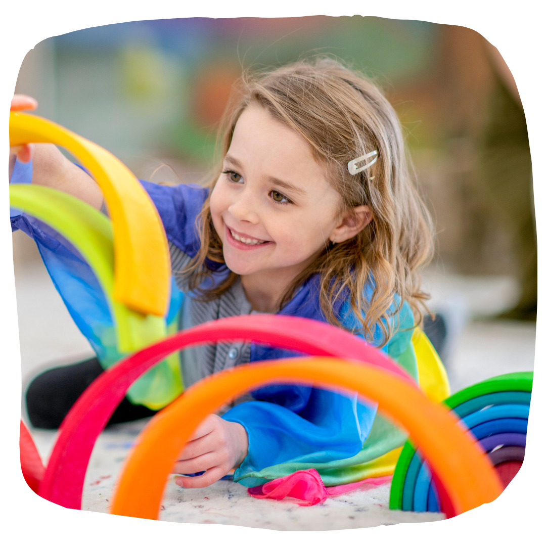 Little kid playing at a table.