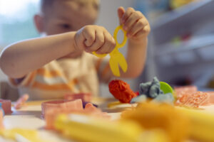 Young child playing with toys on a table.