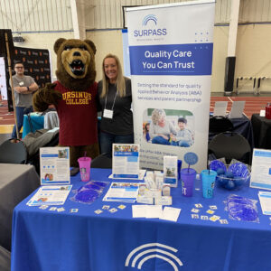 Employees at company booth at sports event.