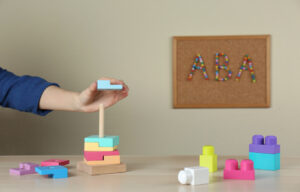 child playing with blocks at table.