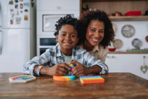 Mom and child together at table inside home.