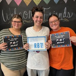 Employees standing with certificates.